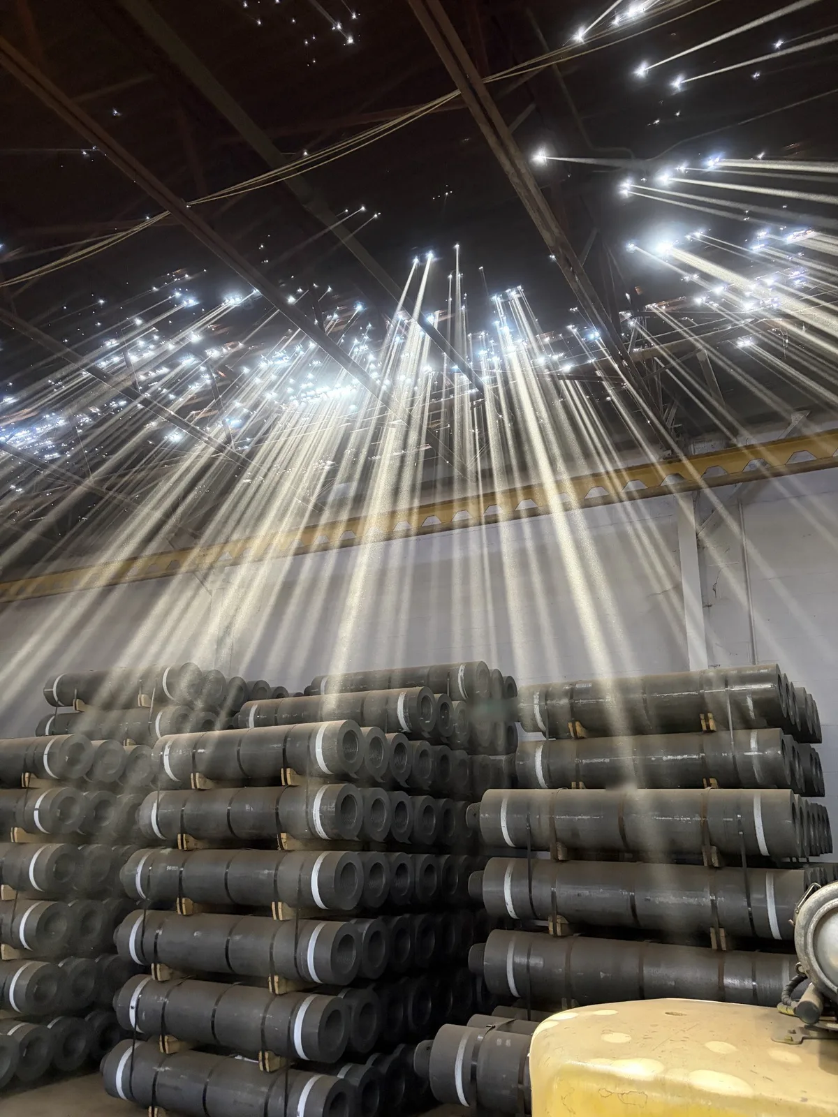 Daylight shining through holes in the rusted steel roof deck of a Cleveland warehouse, found during roof tear-off.