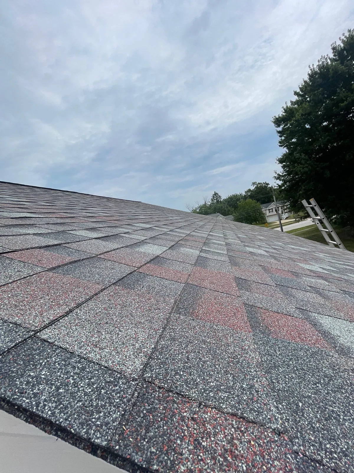 Rooftop view across new blended red and gray architectural shingles on a Medina, Ohio home