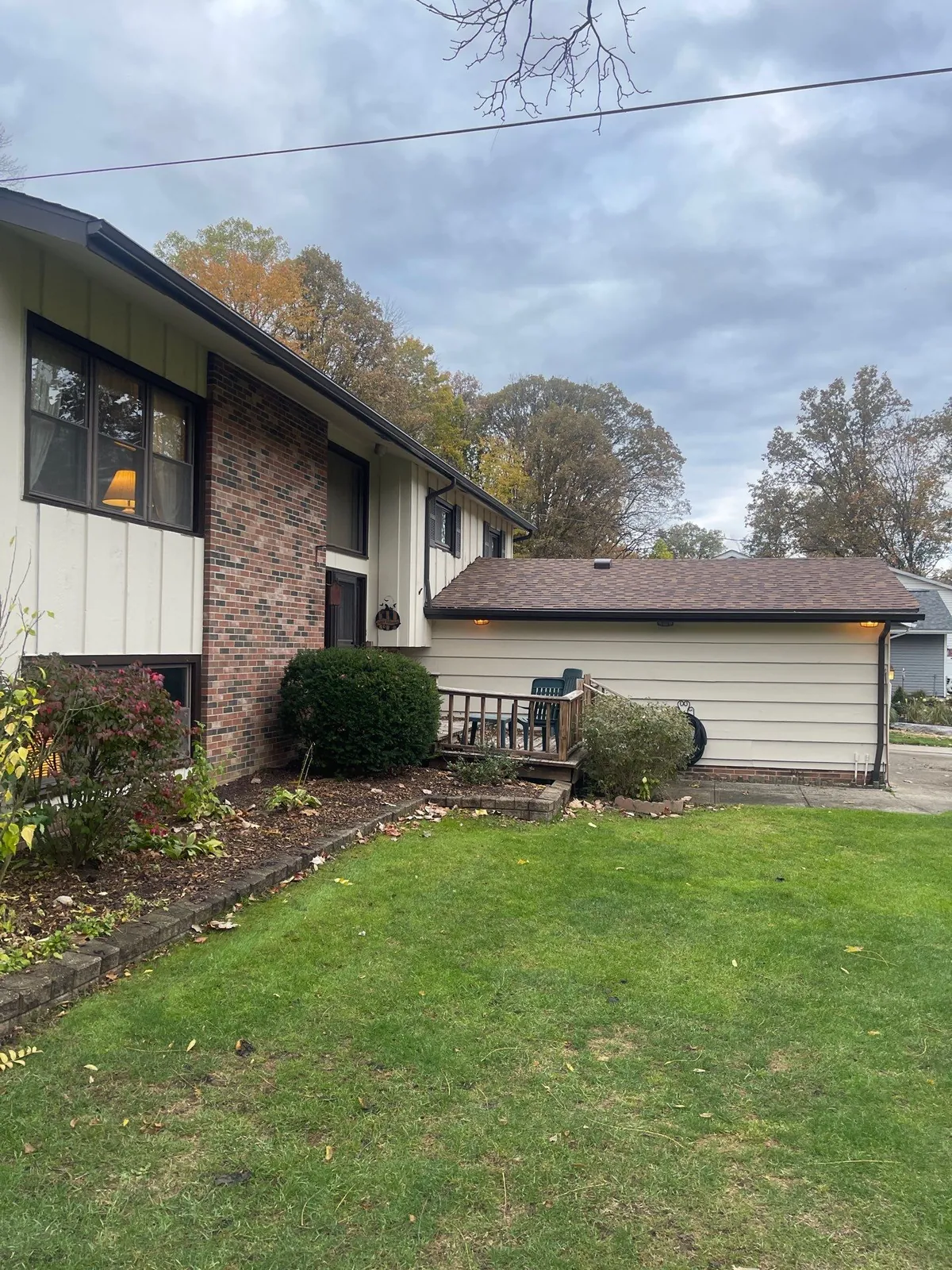 Brick and siding split-level home with a detached garage and new shingle roof in Strongsville, Ohio